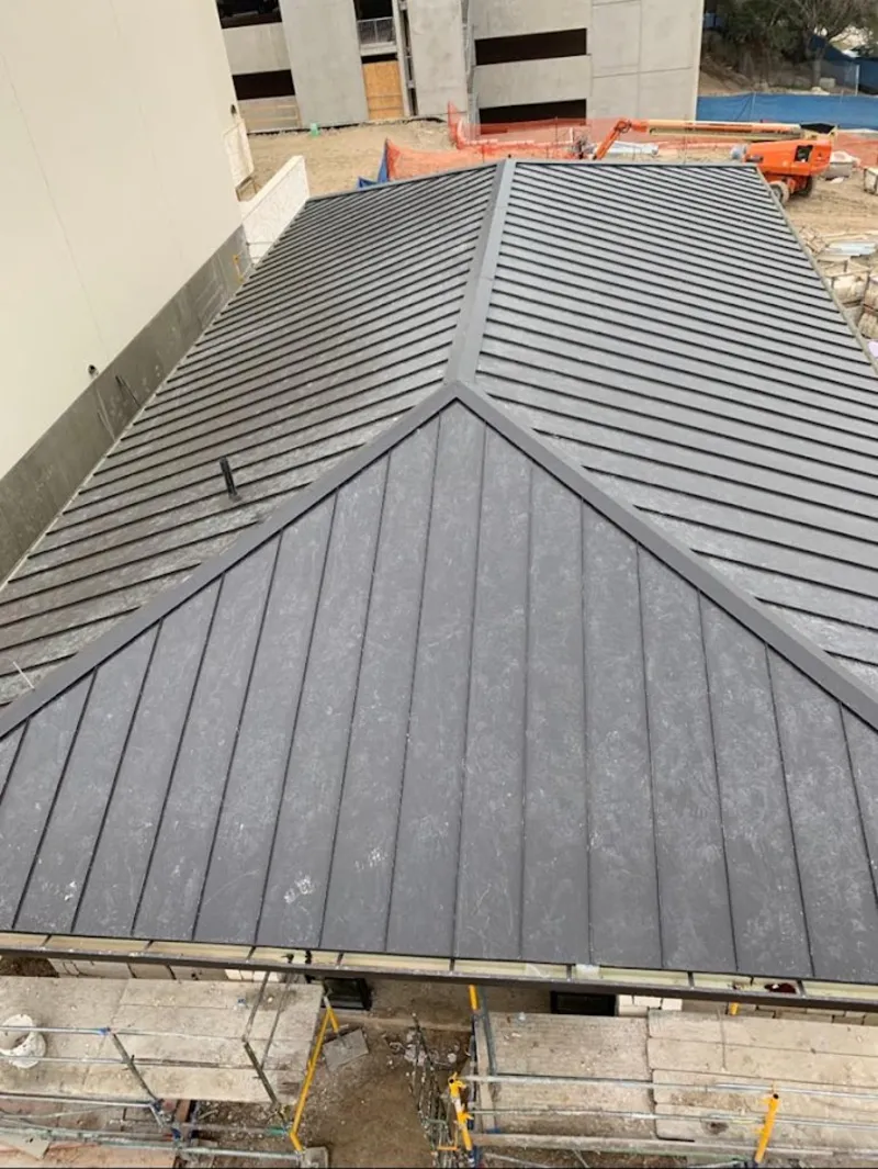 Commercial metal roof construction with crane equipment in Michigan City