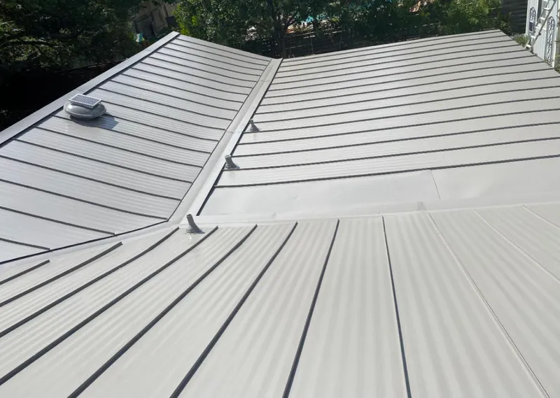 Solar attic fan installed on a metal roof for Roof Ventilation in Michigan City